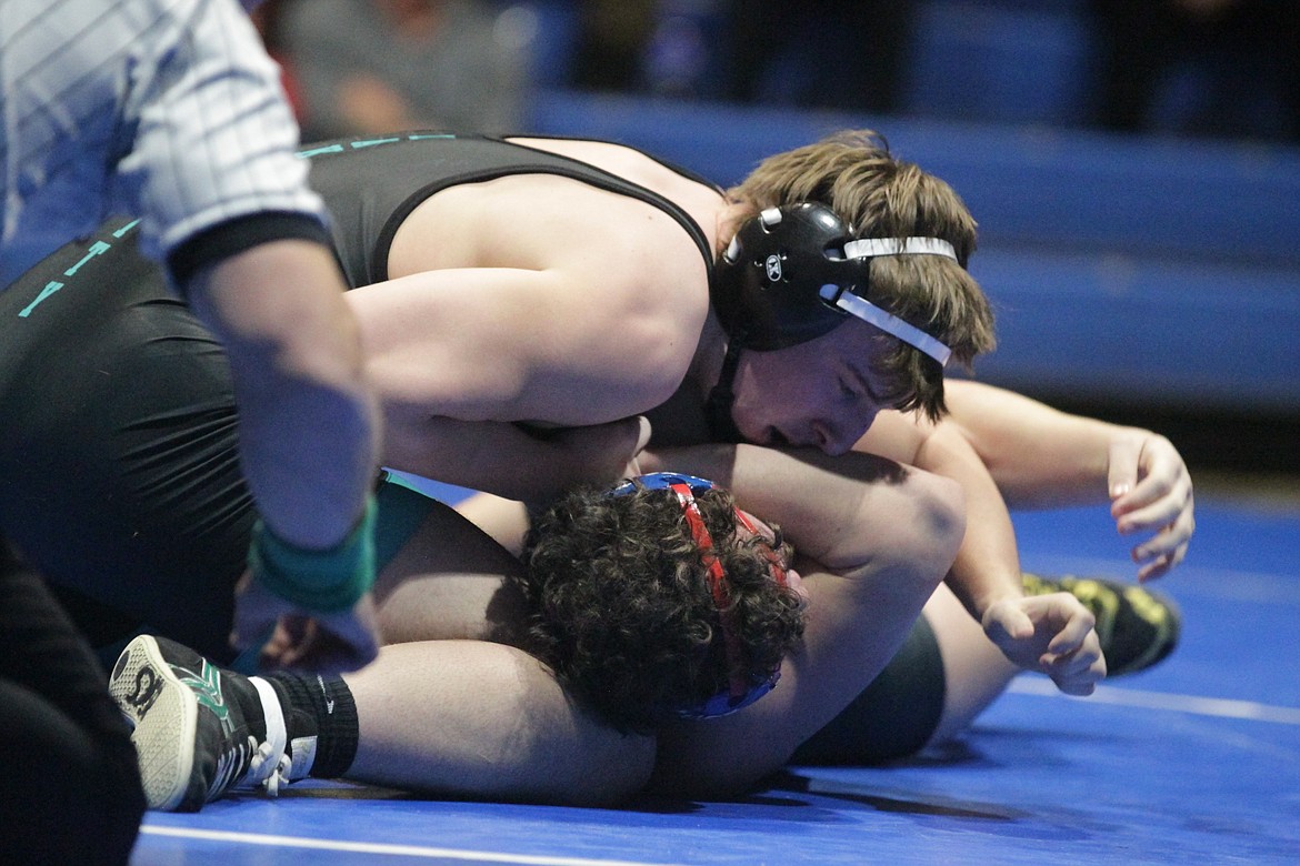 JASON ELLIOTT/Press
Lake City junior Garrett Leonard nears a pin at 195 pounds against Coeur d'Alene sophomore Ty Paulin during the TerHark Cup dual on Thursday at Coeur d'Alene High.