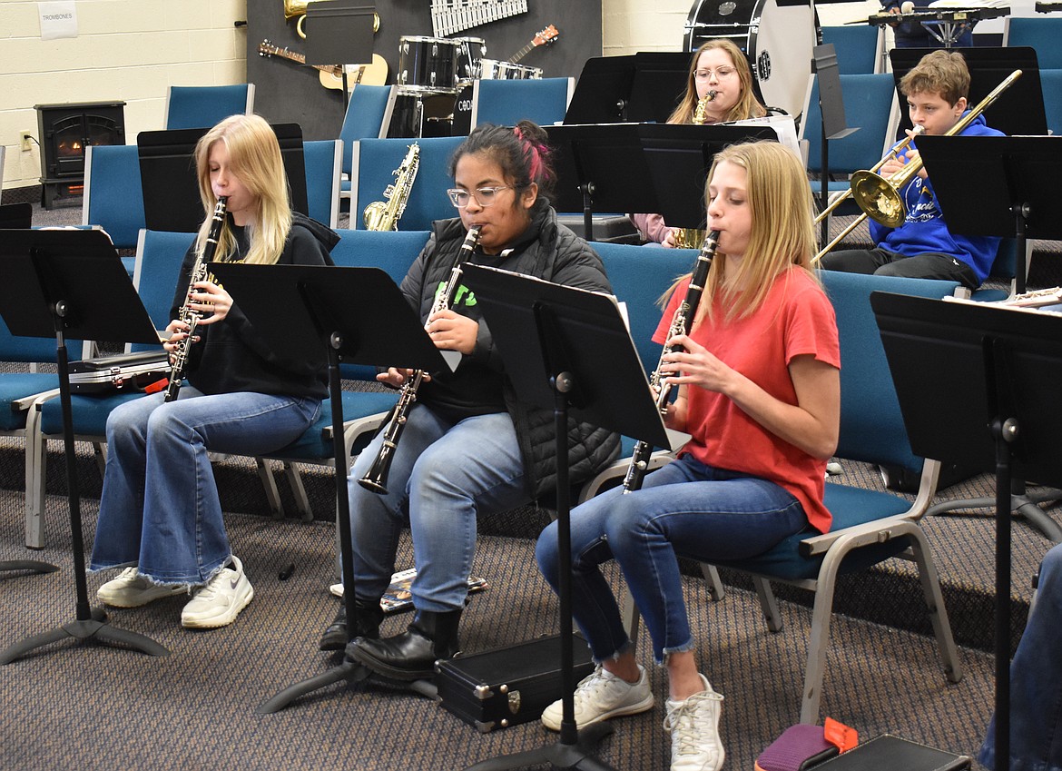 From left: Eighth-grade clarinetists Jade Maygren, Maisy Herrin and Rebecca Wiser practice “Oceans” Thursday at Moses Lake Christian Academy, with Avalyn Bishop on saxophone and Jep Johnson on trombone behind them.