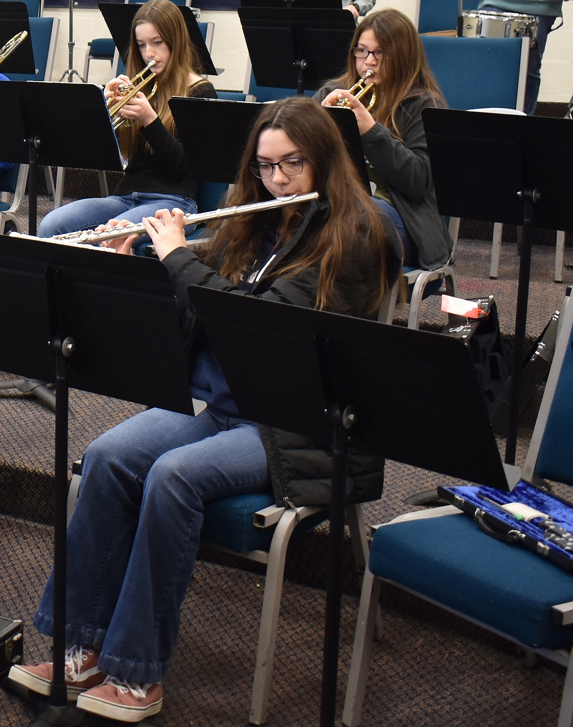 Amber Buell plays the flute Thursday at Moses Lake Christian Academy, backed by trumpet players Vesta Koethke and Elisa Serrato.