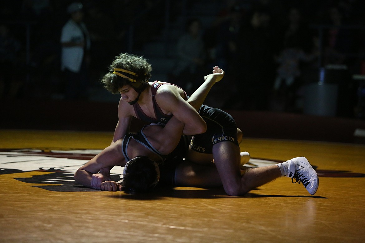 Moses Lake junior Drayden Gaither, top, won by decision in Tuesday’s 126-pound bout against Richland.