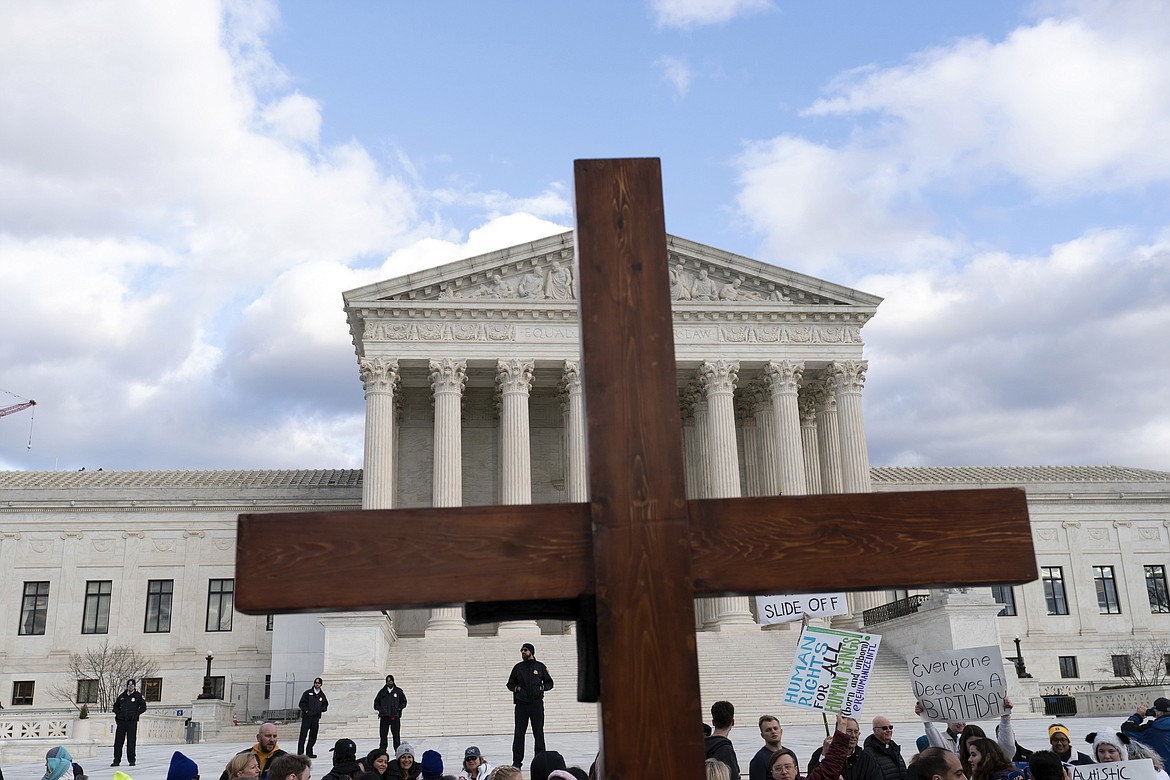 Anti-abortion activists hold a cross as they rally outside of the U.S. Supreme Court during the March for Life in Washington, Friday, Jan. 20, 2023. (AP Photo/Jose Luis Magana, File)