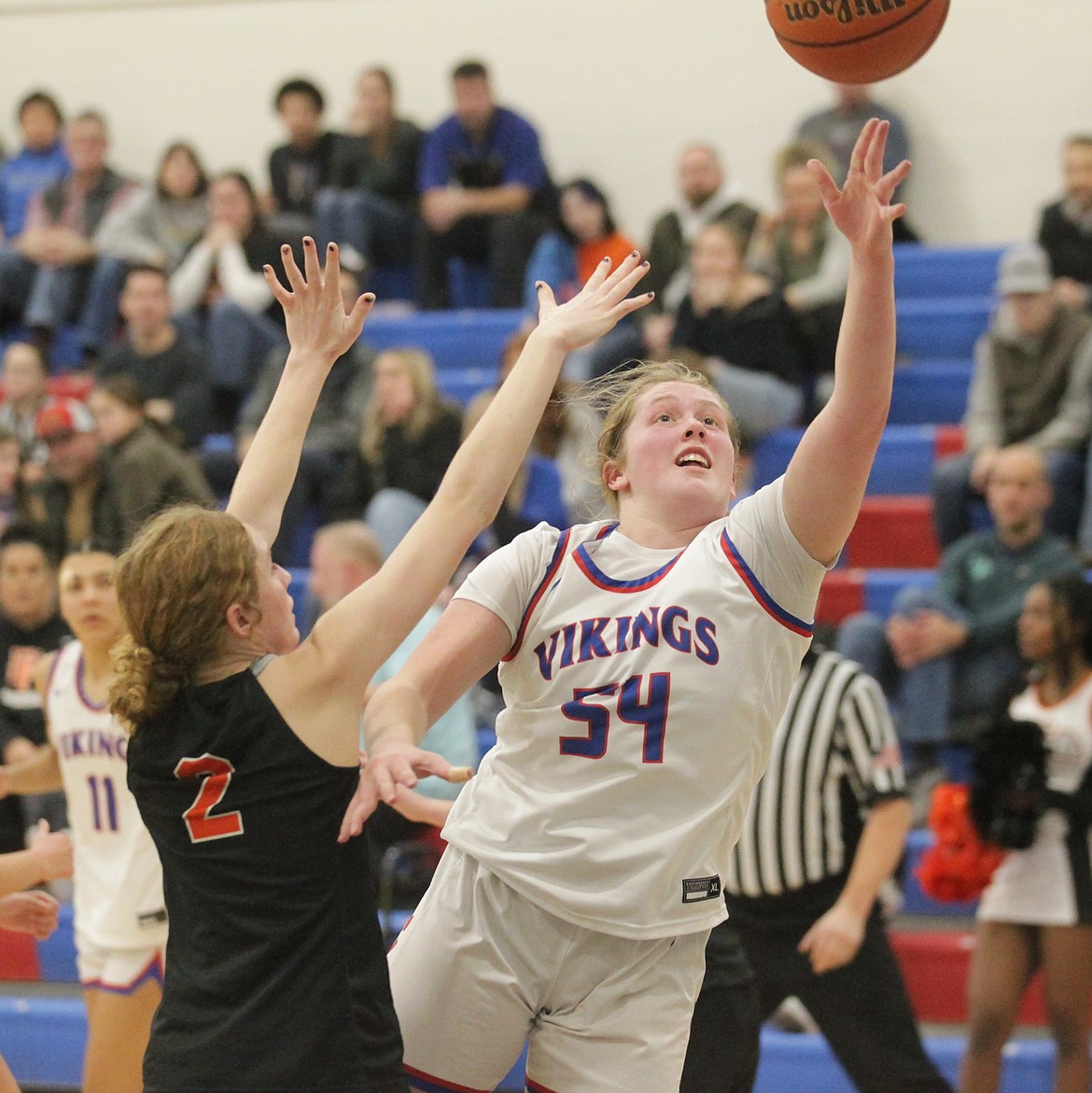 MARK NELKE/Press
Kelsey Carroll (54) of Coeur d'Alene puts up a shot as Kinlee McLean (2) defends on Friday night at Coeur d'Alene High's Viking Court.