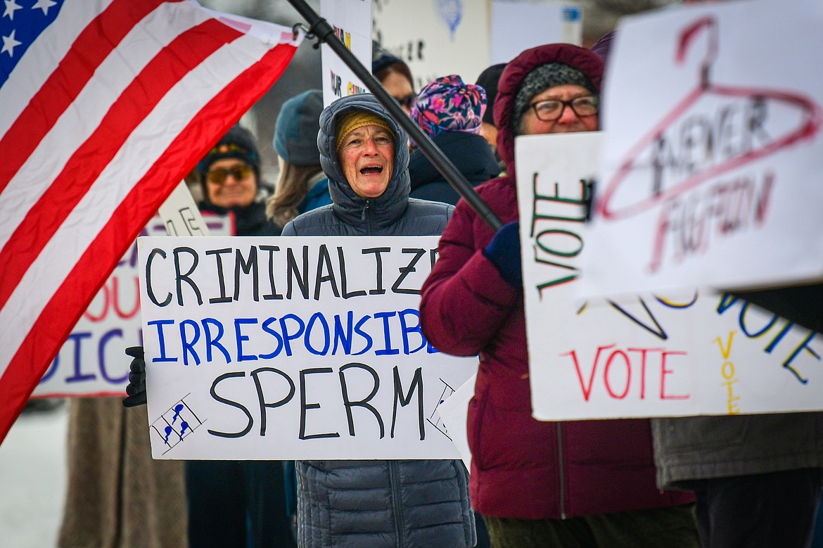 Participants gather at Depot Park in Kalispell to hold signs and wave to passing motorists at a gathering organized by Flathead Democrats In support of the "Bigger Than Roe -- National Women's March" on Saturday, Jan. 20. (Casey Kreider/Daily Inter Lake)