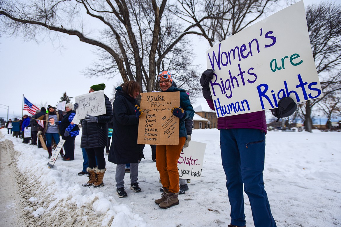 Participants gather at Depot Park in Kalispell to hold signs and wave to passing motorists at a gathering organized by Flathead Democrats In support of the "Bigger Than Roe -- National Women's March" on Saturday, Jan. 20. (Casey Kreider/Daily Inter Lake)