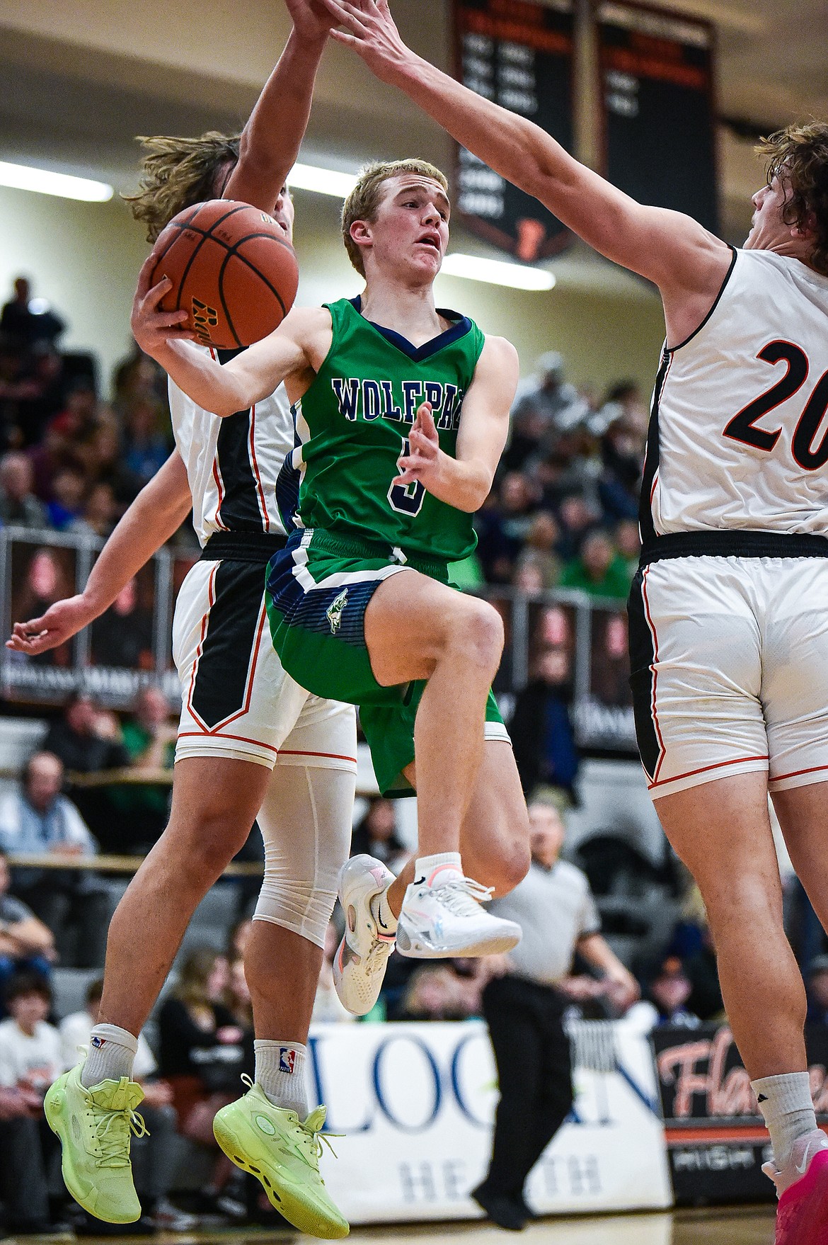 Glacier's Easton Kauffman (5) drives and dishes under the basket in the first half against Flathead at Flathead High School on Friday, Jan. 19. (Casey Kreider/Daily Inter Lake)