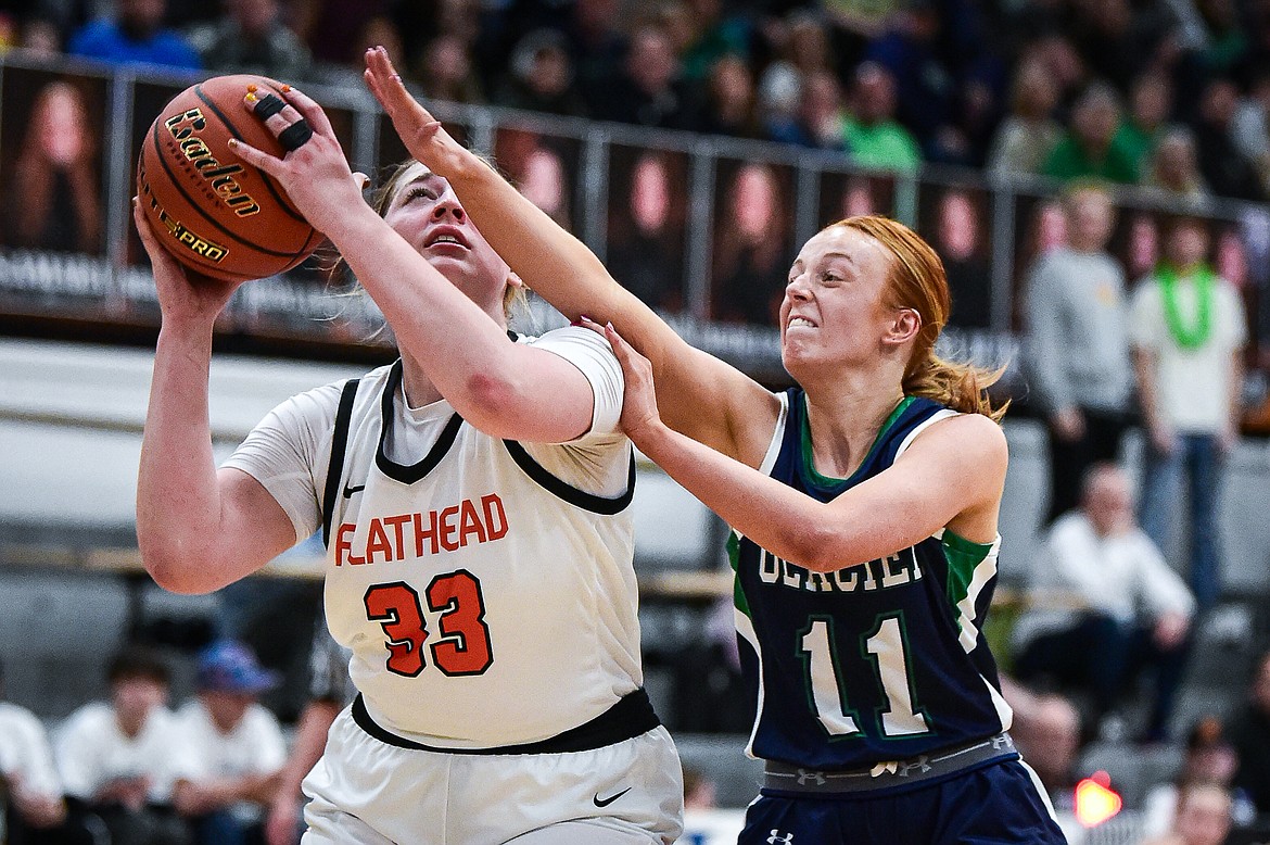 Flathead's Sami Dalager (33) is fouled by Glacier's Kenedee Moore (11) in the second half at Flathead High School on Friday, Jan. 19. (Casey Kreider/Daily Inter Lake)