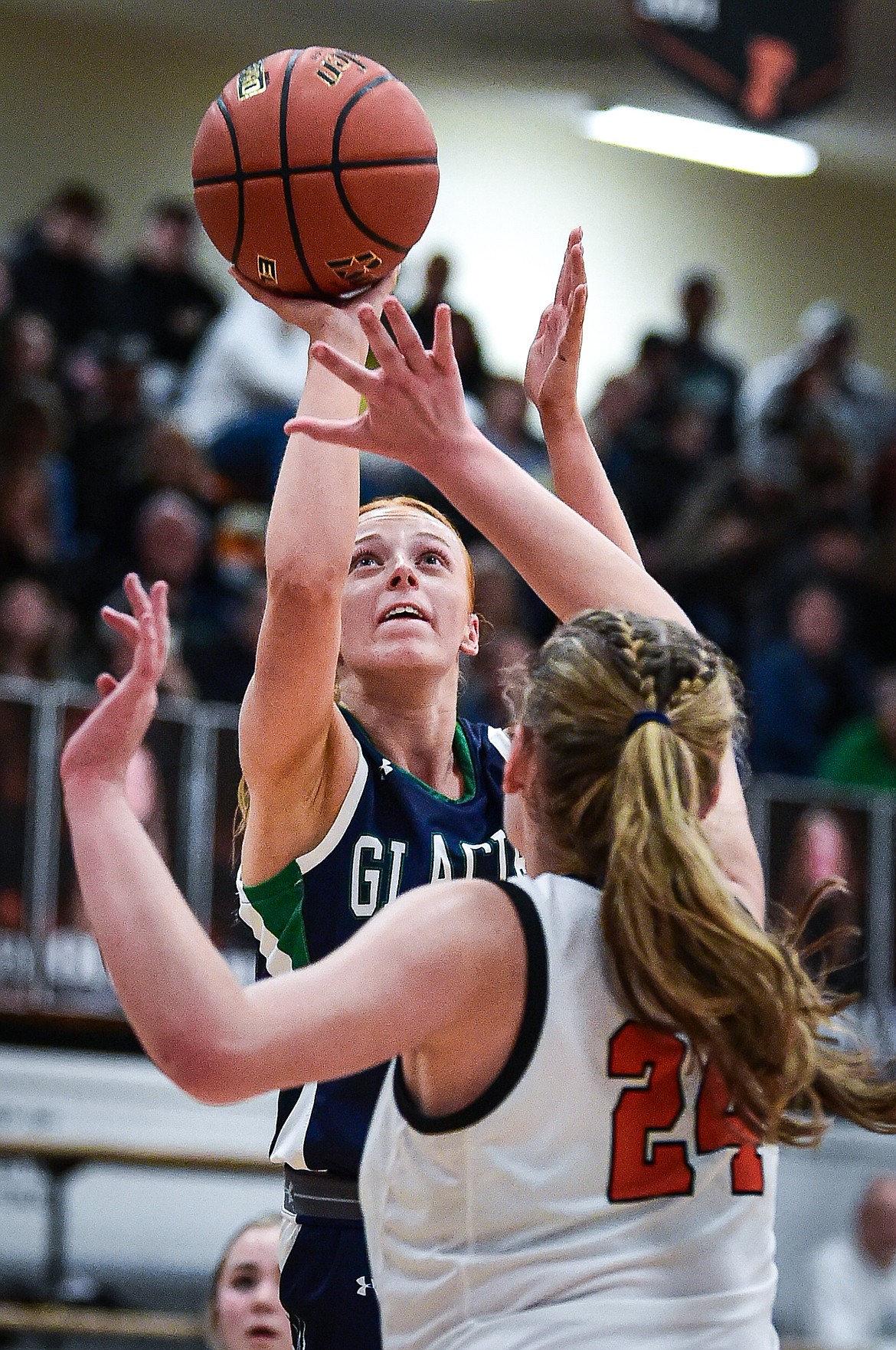 Glacier's Kenedee Moore (11) shoots against Flathead's Mattie Thompson (24) in the first half at Flathead High School on Friday, Jan. 19. (Casey Kreider/Daily Inter Lake)