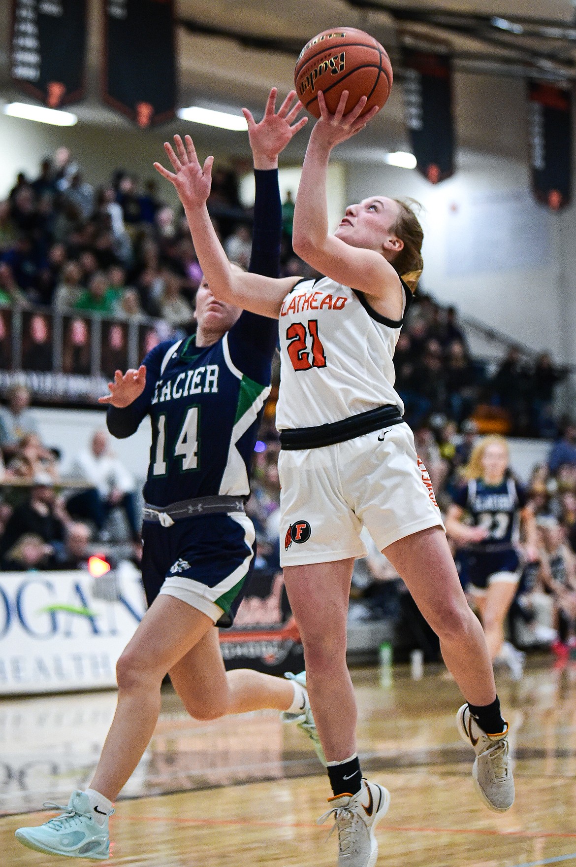 Flathead's Harlie Roth (21) drives to the basket guarded by Glacier's Karley Allen (14) at Flathead High School on Friday, Jan. 19. (Casey Kreider/Daily Inter Lake)