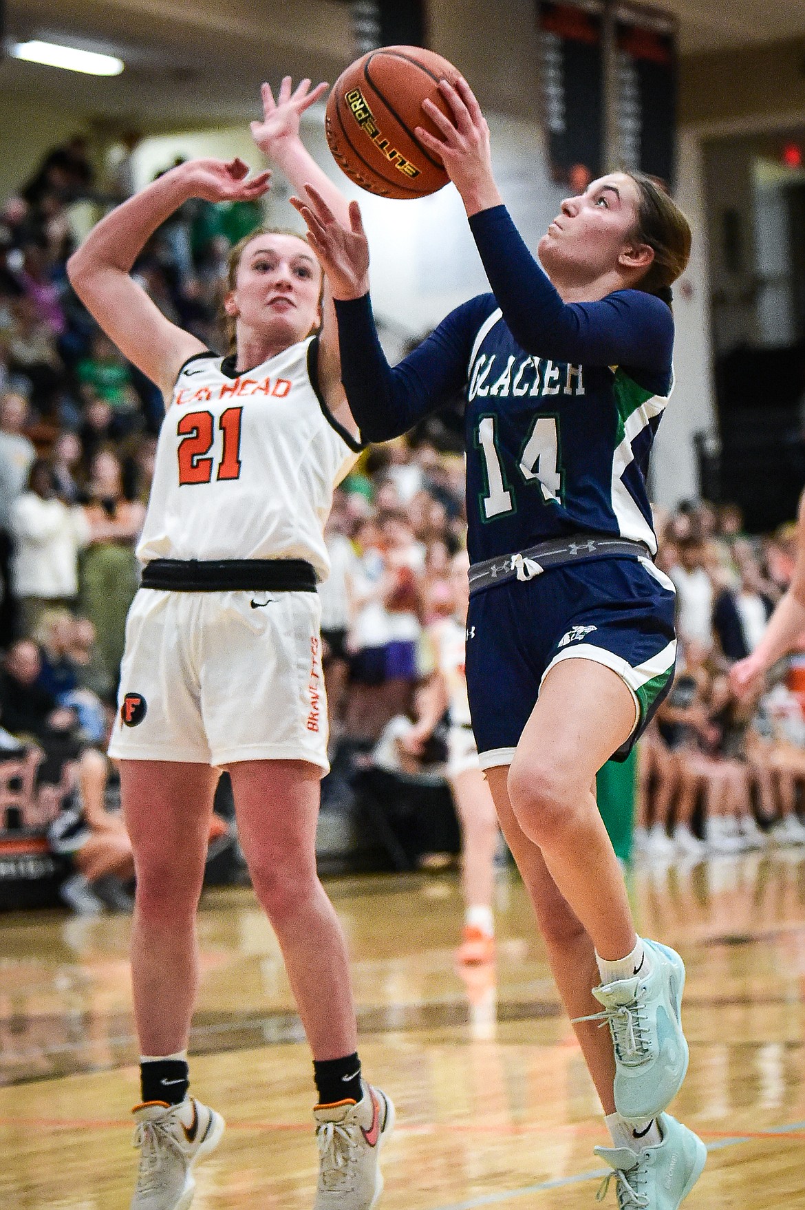 Glacier's Karley Allen (14) drives to the basket against Flathead's Harlie Roth (21) at Flathead High School on Friday, Jan. 19. (Casey Kreider/Daily Inter Lake)