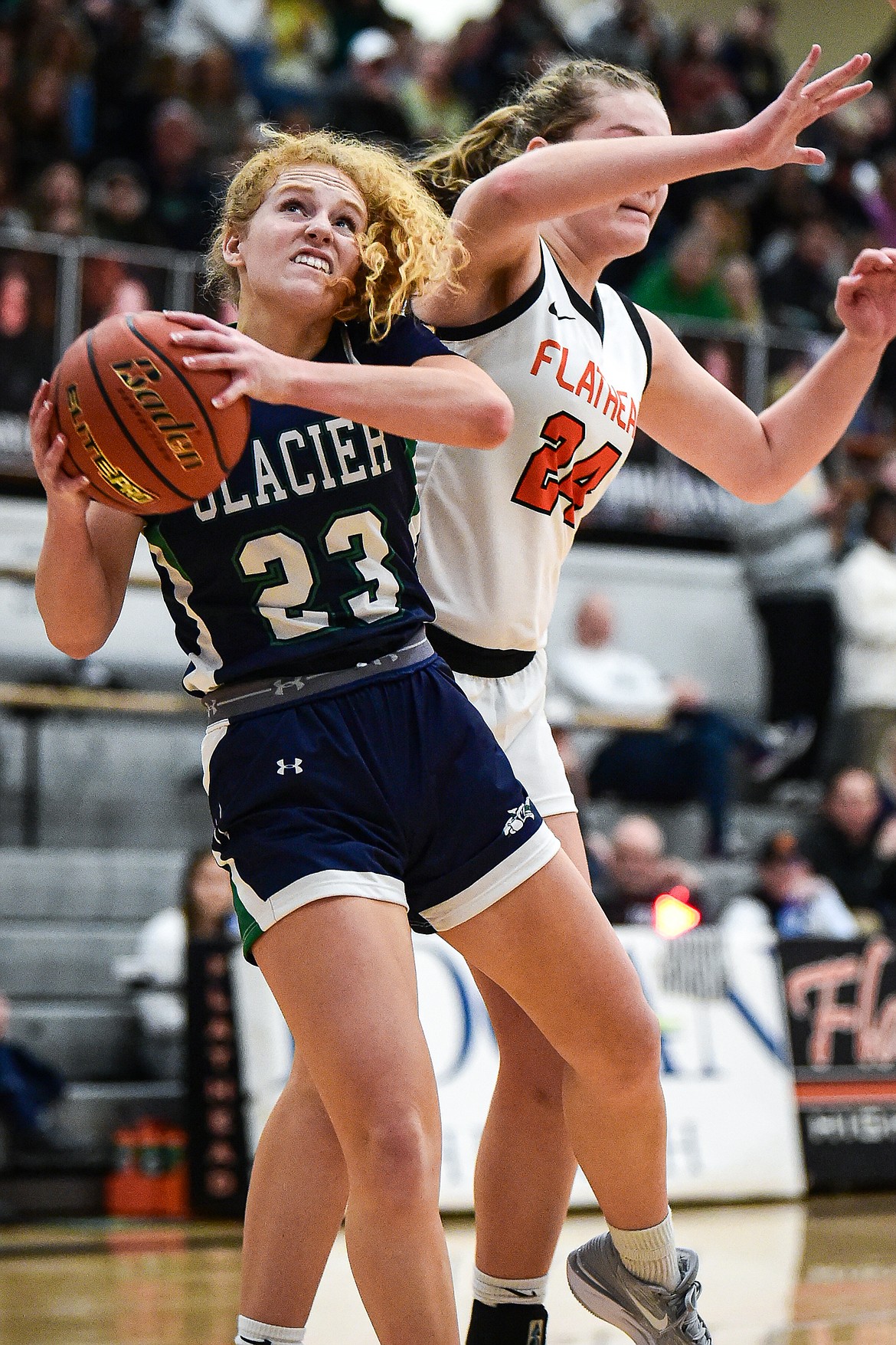 Glacier's Reese Ramey (23) drives to the basket against Flathead's Mattie Thompson (24) at Flathead High School on Friday, Jan. 19. (Casey Kreider/Daily Inter Lake)