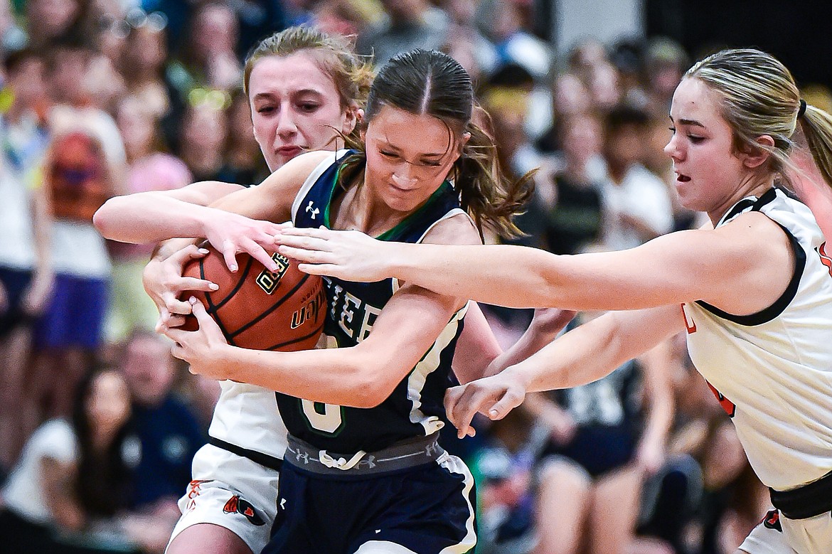 Glacier's Kiera Sullivan (5) battles for possession with Flathead's Harlie Roth (21) and Quin Tennison (10) in the first half at Flathead High School on Friday, Jan. 19. (Casey Kreider/Daily Inter Lake)