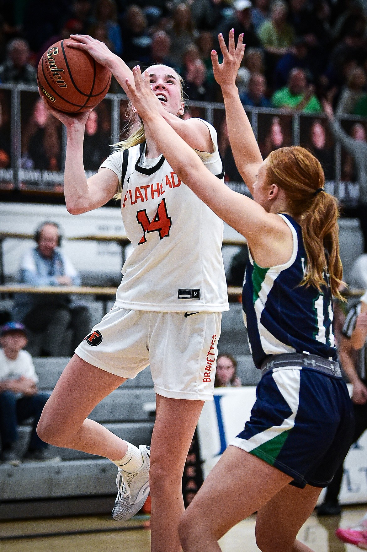 Flathead's Kennedy Moore (14) drives to the basket against Glacier's Kenedee Moore (11) at Flathead High School on Friday, Jan. 19. (Casey Kreider/Daily Inter Lake)
