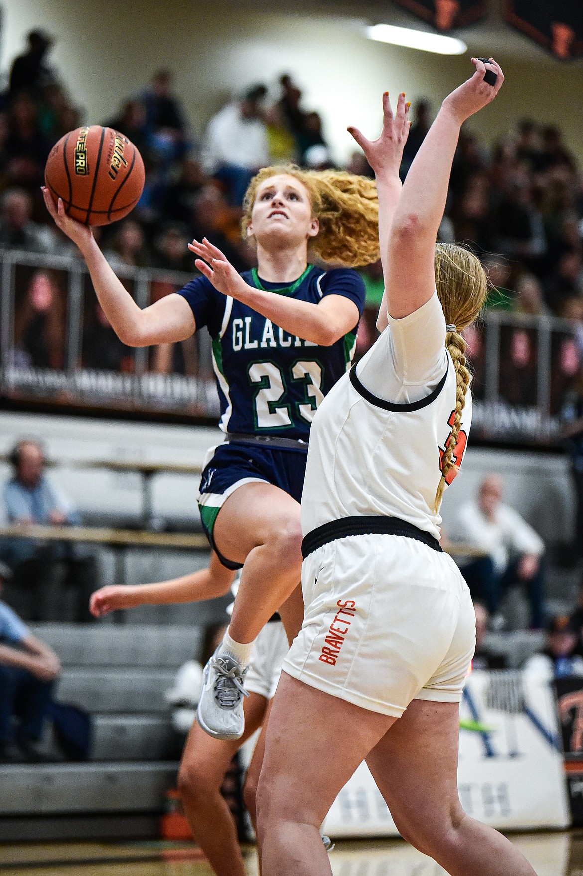 Glacier's Reese Ramey (23) drives to the basket against Flathead's Sami Dalager (33) at Flathead High School on Friday, Jan. 19. (Casey Kreider/Daily Inter Lake)