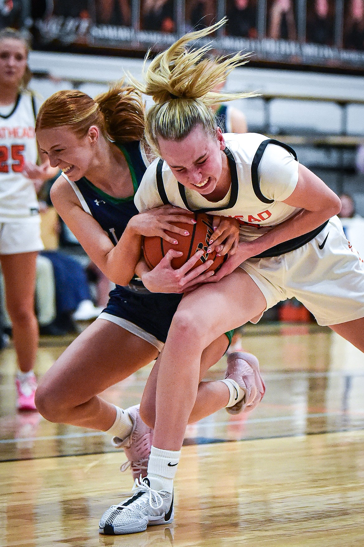 Flathead's Kennedy Moore (14) battles for possession with Glacier's Kenedee Moore (11) in the first half at Flathead High School on Friday, Jan. 19. (Casey Kreider/Daily Inter Lake)