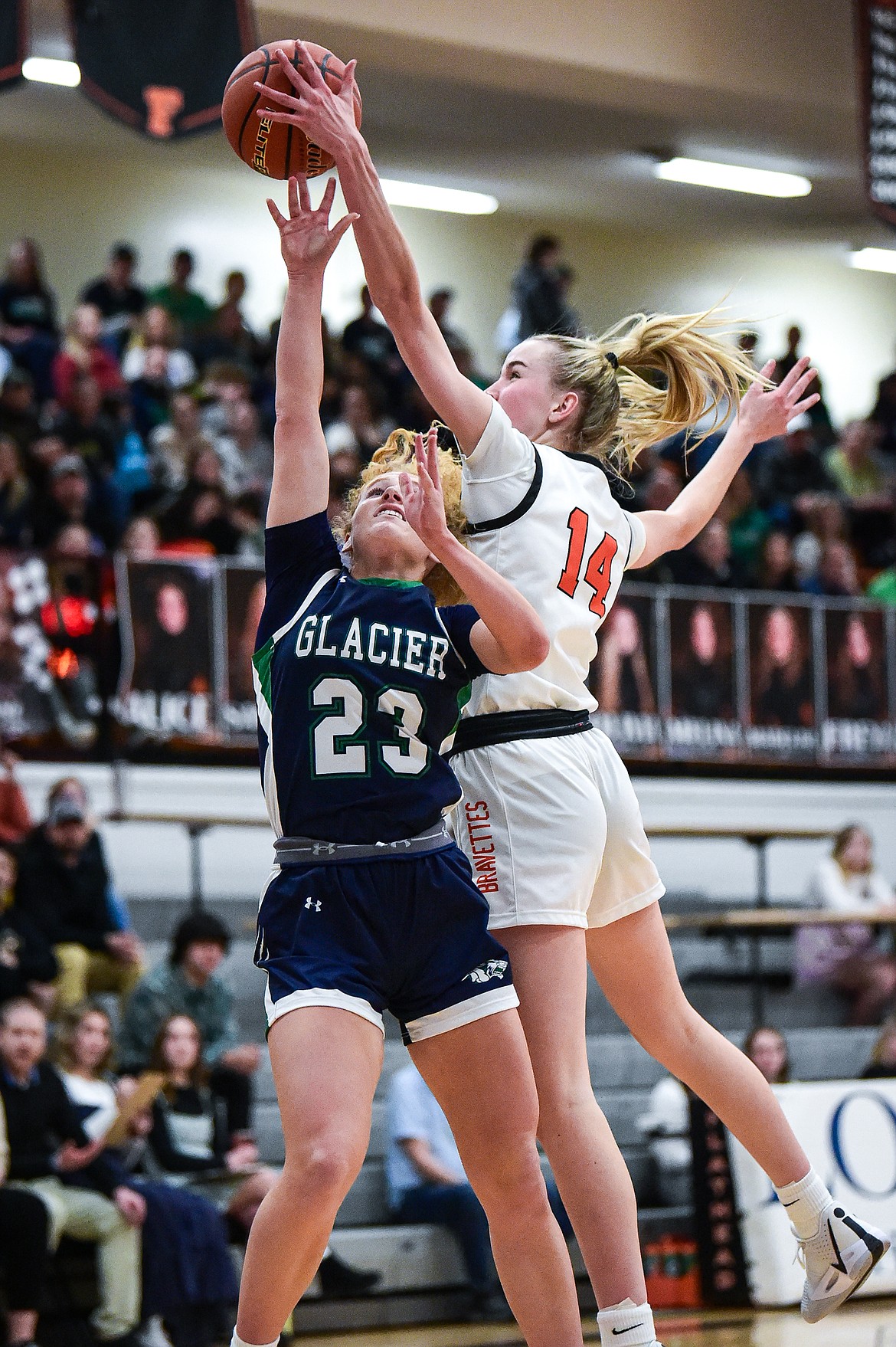 Flathead's Kennedy Moore (14) blocks a layup attempt by Glacier's Reese Ramey (23) at Flathead High School on Friday, Jan. 19. (Casey Kreider/Daily Inter Lake)