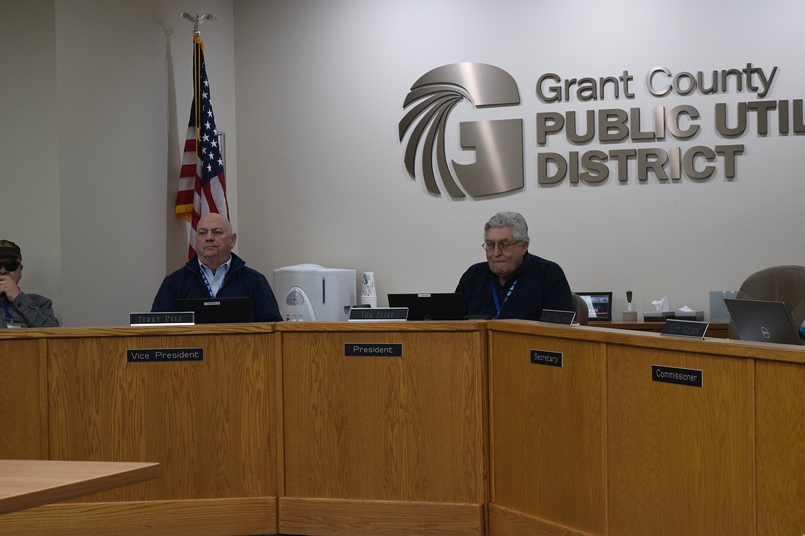 Grant County Public Utility District Vice President Terry Pyle, left, and President Tom Flint, right, listen to a presentation on the PUD’s bi-annual customer satisfaction survey which is conducted during odd-numbered years by Strategies 360, a consulting firm the PUD has worked with for several years now.