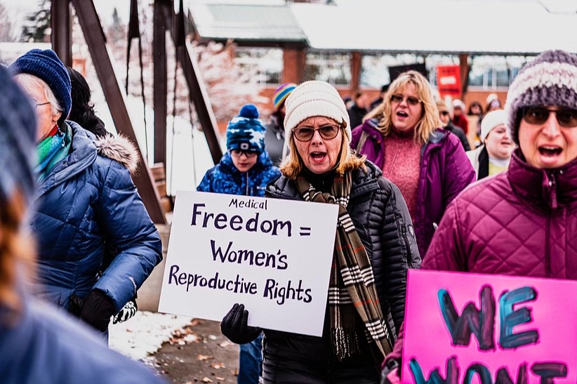 A marcher holds up a sign with the text, "Medical freedom equals women's rights" during the 2023 Women's March in Coeur d'Alene.