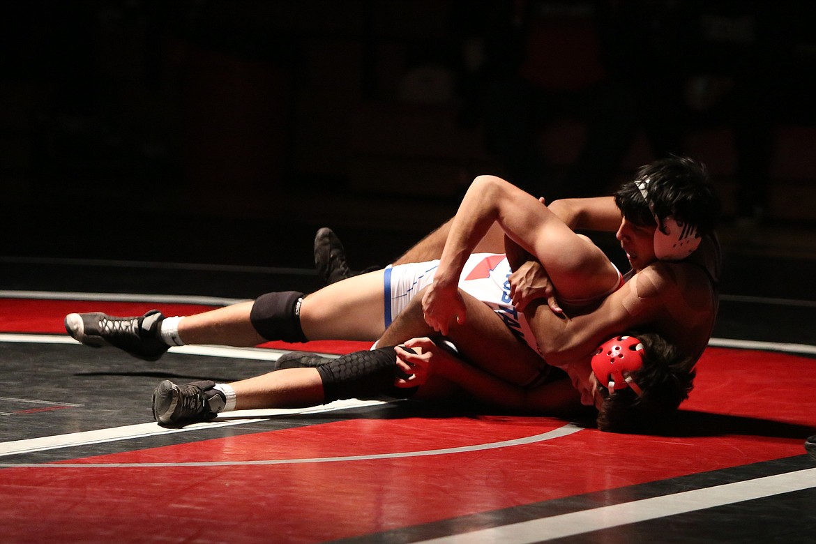 Othello junior Ismael Torres, background, won his first match Thursday night by decision against Prosser’s Benjamin Maldonado, foreground.