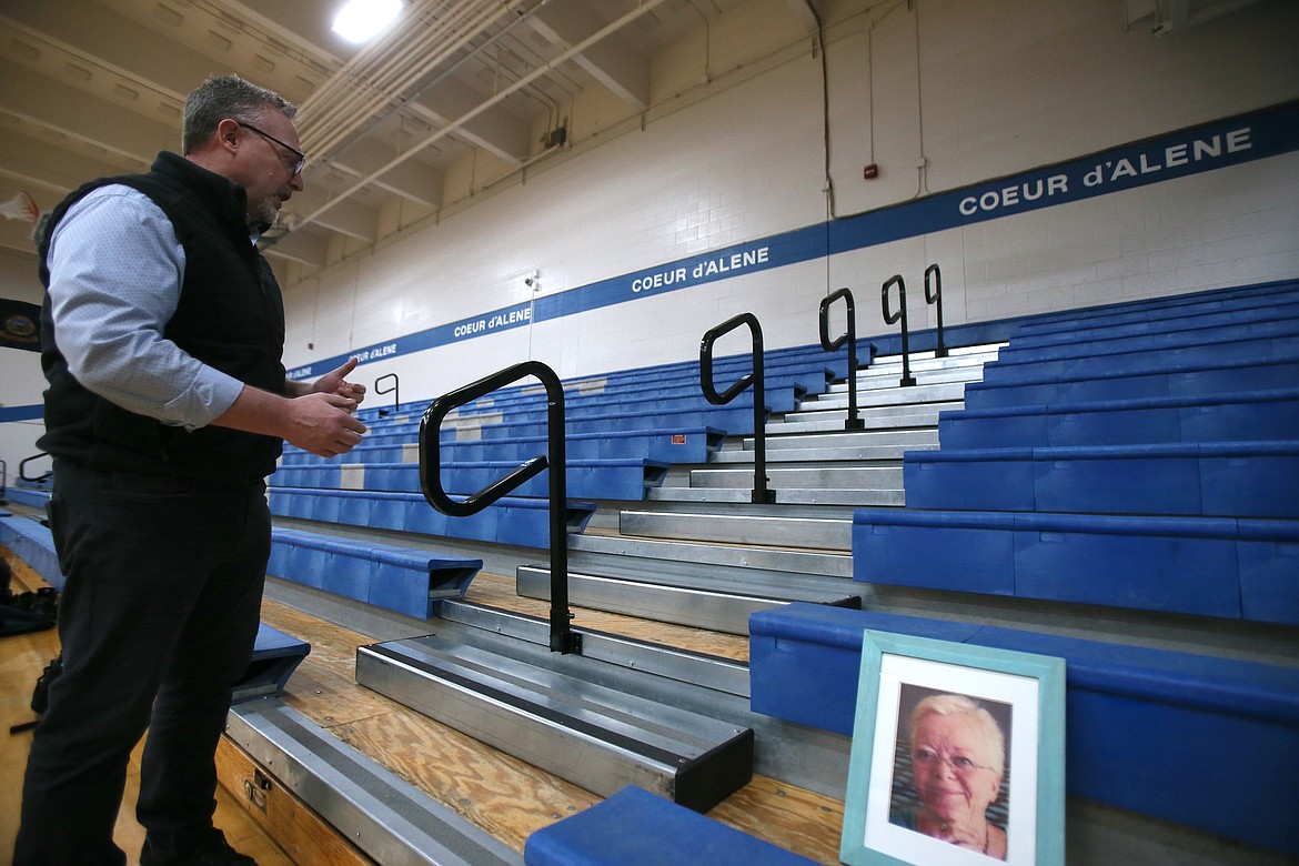 Handrails and steps were added to bleachers at Coeur d'Alene High School thanks to the work of Greg Washington, who was inspired by his late mother, Ann Washington, update their accessibility. Washington is seen in the gym Monday with a photo of his mom.