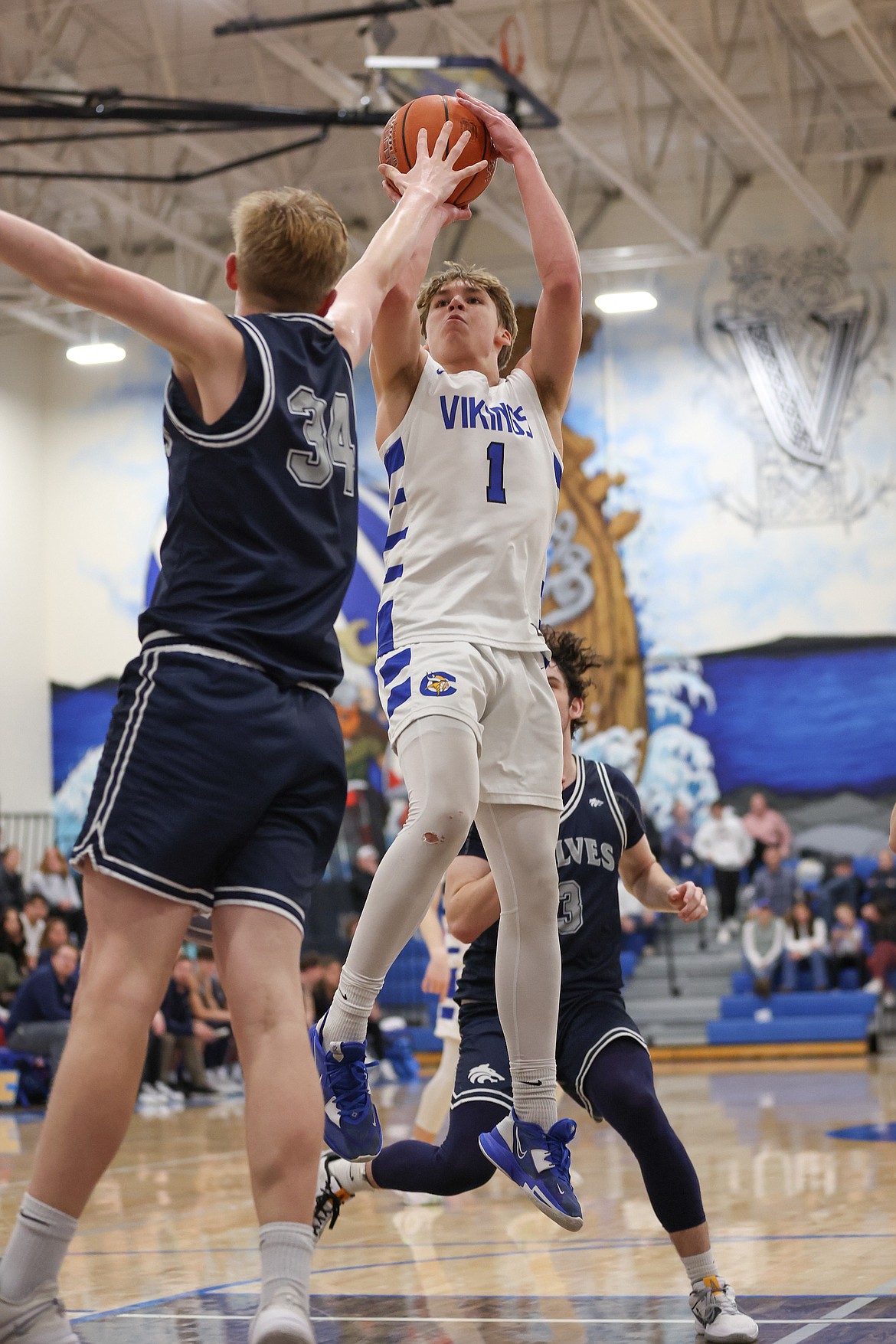 JASON DUCHOW PHOTOGRAPHY
Coeur d'Alene senior guard Logan Orchard puts up a short over Lake City freshman forward Jordan Carlson during the second half of Monday's Inland Empire League game at Viking Court.