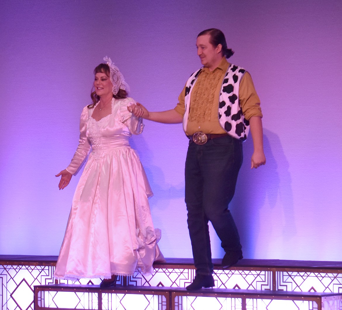 Shannon Hintz, left, and her partner Anthony Whipple enter the stage to be introduced to the audience at Dancing with the Moses Lake Stars Friday.