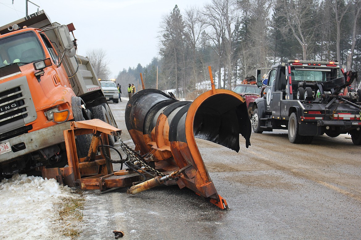 There were no injuries at mile marker 6 on east Mullan Road outside of Superior when a vehicle crossed the center line and made contact with a Montana DOT snowplow. Ice was reported as a key factor in the collision. (Monte Turner/Mineral Independent)