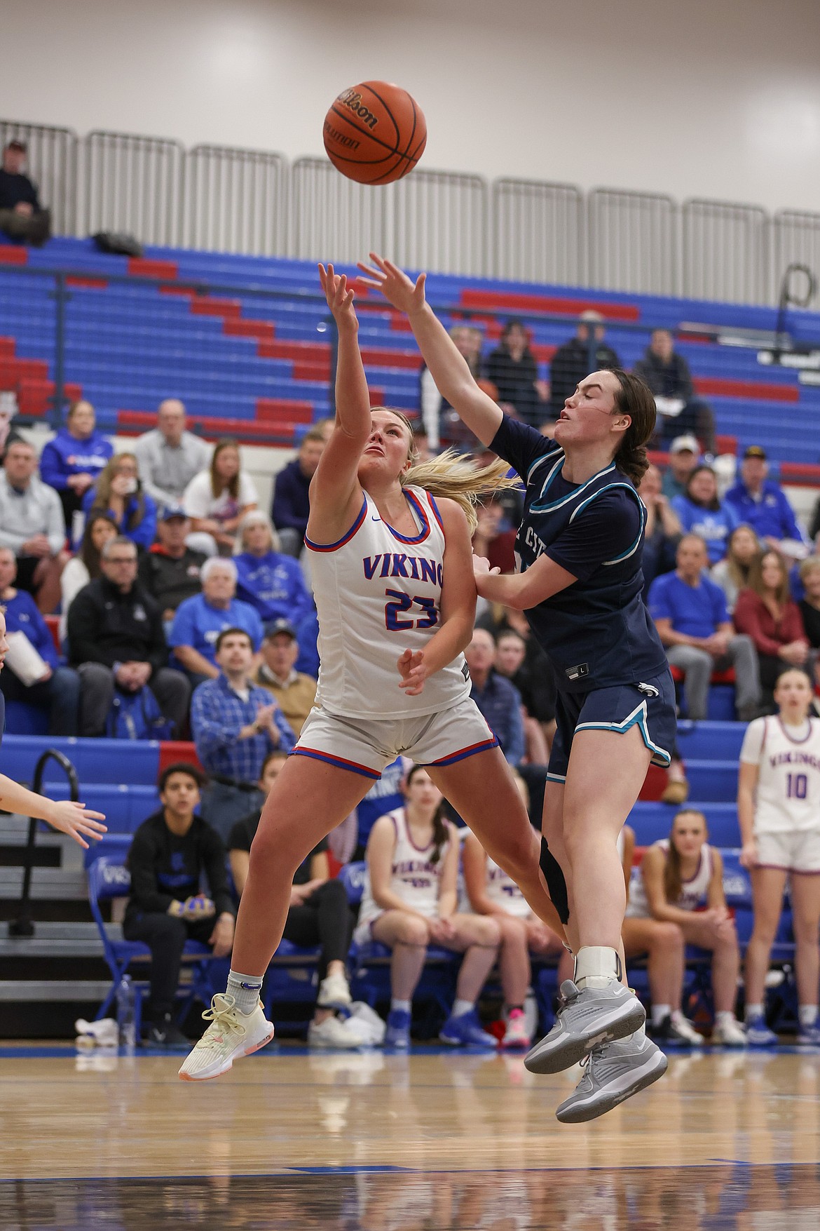 JASON DUCHOW PHOTOGRAPHY
Kendall Holecek (23) of Coeur d'Alene puts up a shot as Sadie Zimmerman of Lake City defends on Monday night at Coeur d'Alene High's Viking Court.