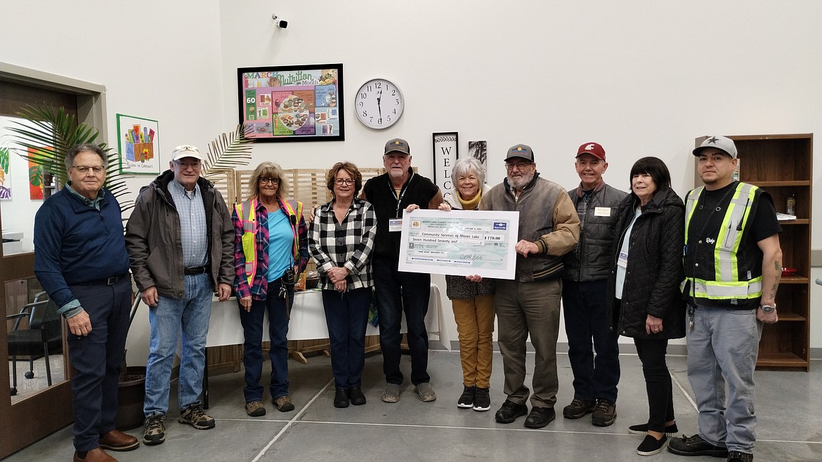 Moses Lake Food Bank staff and directors accept a donation from the Moses Lake Classic Car Club earlier this month. Donations of money, food and volunteer time are accepted at the food bank year-round, said Director Peny Archer.