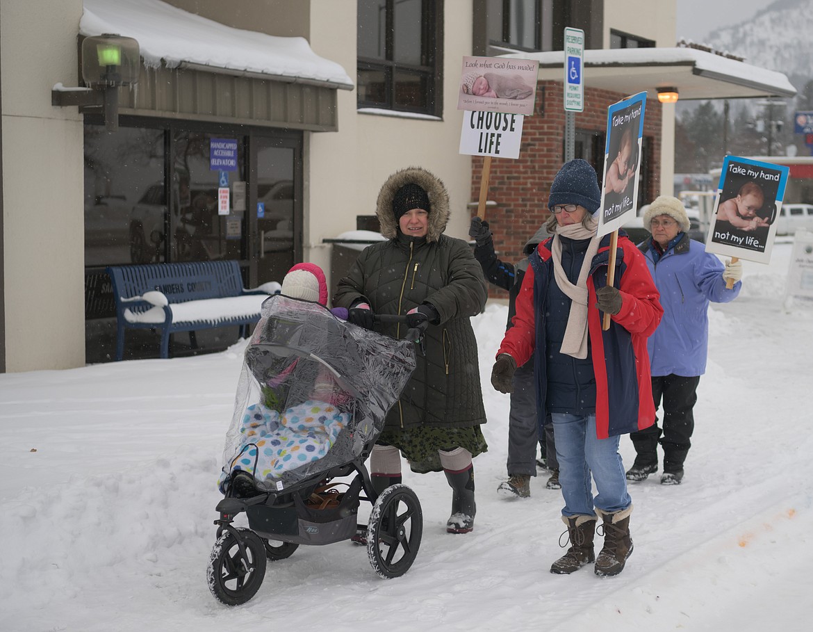 Marchers line the sidewalks in Thompson Falls. (Tracy Scott/Valley Press)