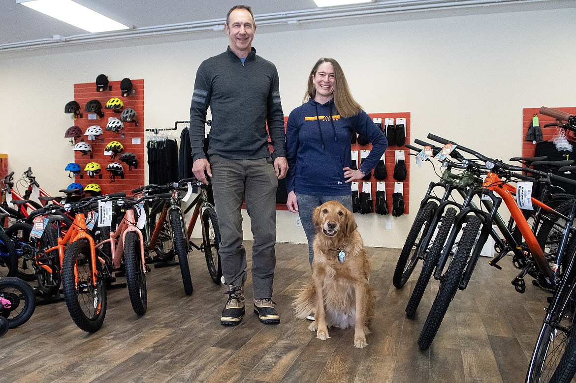Co-owners Travis Coleman and Lynn Foster, along with shop dog Loki, pose for a photo in A7 Cycle’s new location at 28 Fourth Street West in Columbia Falls on Thursday, Jan. 11.