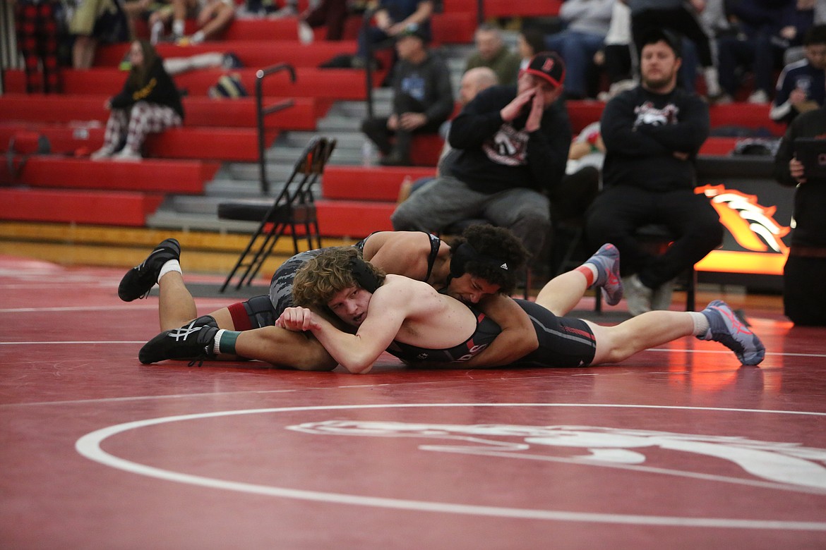 ACH junior Paul Stout, foreground, and LRS senior John Branham, background, wrestle in the 190-pound third/fourth-place match at Saturday’s Bronco Invitational.