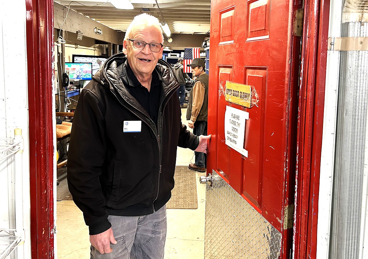 Del Simchuk opens the door leading to the outside area at St. Vincent de Paul North Idaho.