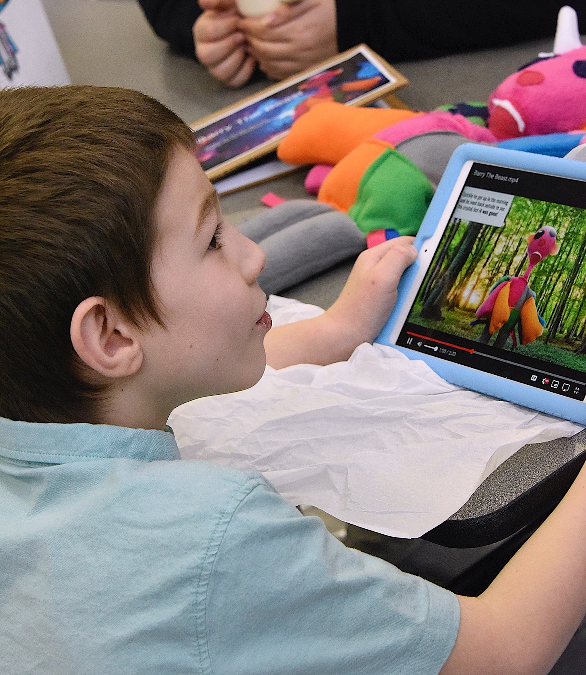 First grader Drake Cole looks at his digital storybook about his monster. (Berl Tiskus/Leader)