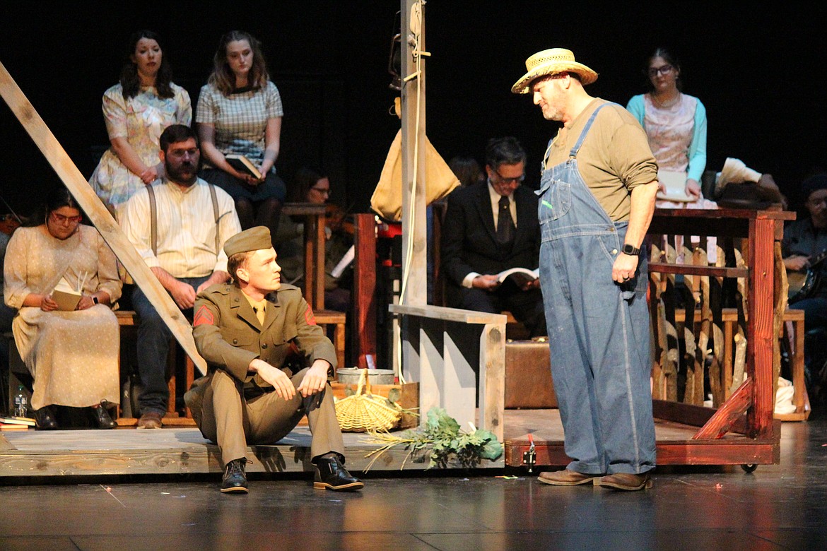 Billy Cane (Taggart Hodges) gets some very bad news indeed from his father (Troy Holt), right, as the “Bright Star” chorus looks on.