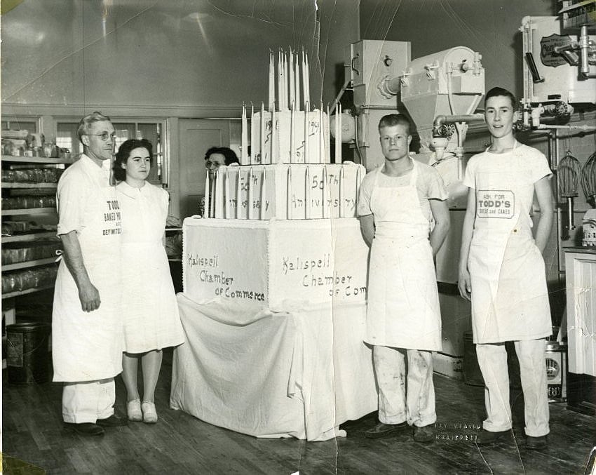 The staff of Todd’s Bake Shop in Kalispell next to a cake baked for the 50th anniversary of the Kalispell Chamber of Commerce, taken around 1954. Photo by Ray Weaver, courtesy of Northwest Montana History Museum.