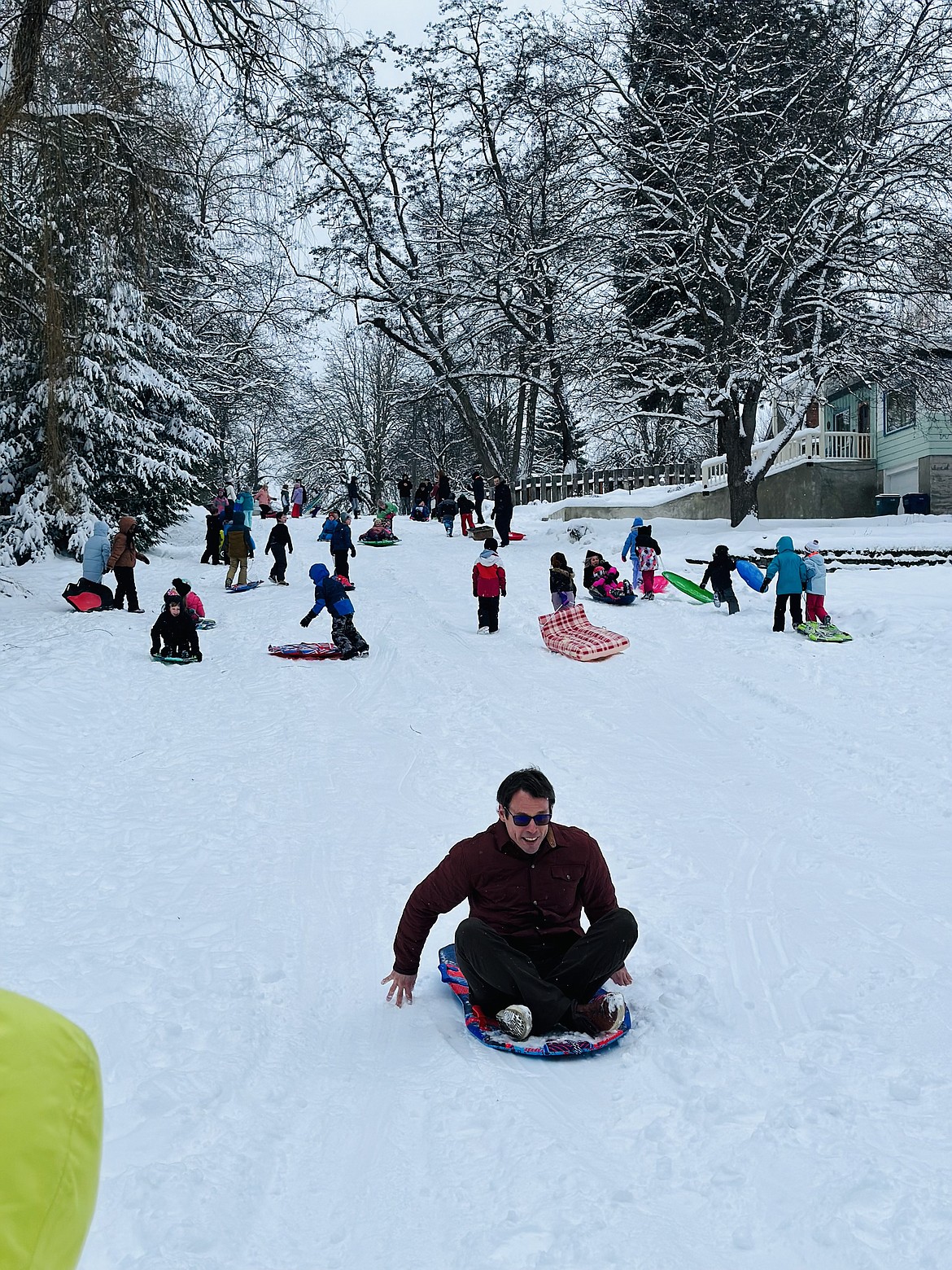 Sorensen Magnet School of the Arts and Humanities Principal Brett DePew sails down Boyd Hill during the school's first "Gaining Momentum" sled day Friday morning. The day was a celebration of the school year's half-way mark, as well as an opportunity for third graders to see the concepts of force and motion in action.