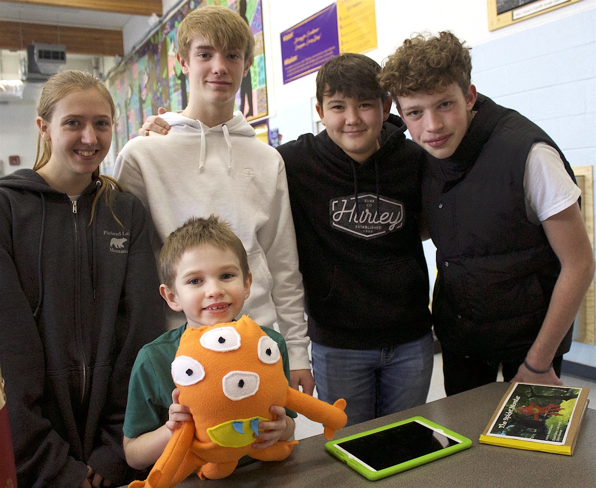 Polson students Lilly Bisson (10th grade), Luke Horner, Zayne Newman and Aedan Dupuis (eighth grade) and Bruce McNutt (first grade) worked together in a unique collaborative project that involved reading, writing, sewing, technology and monsters. (Tami Morrison photo)