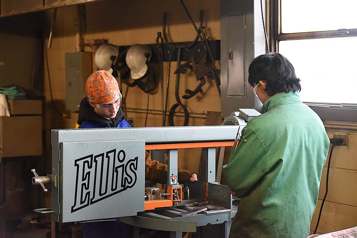 Riley Orsborn, left, and Gabe Gier work on cutting test plates at Libby Middle High School Tuesday, Jan. 25, 2023. (Scott Shindledecker/The Western News)