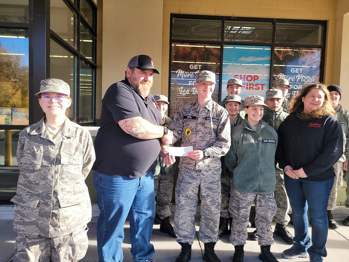 Owners of the Grocery Outlet location in Ephrata, Steve and Heather Brown, hand over a check to the Ephrata Civil Air Patrol last year in support of CAP’s participation in the Wreaths Across America program. Since purchasing the Ephrata store in late 2022, the Browns have worked to be involved in the community.