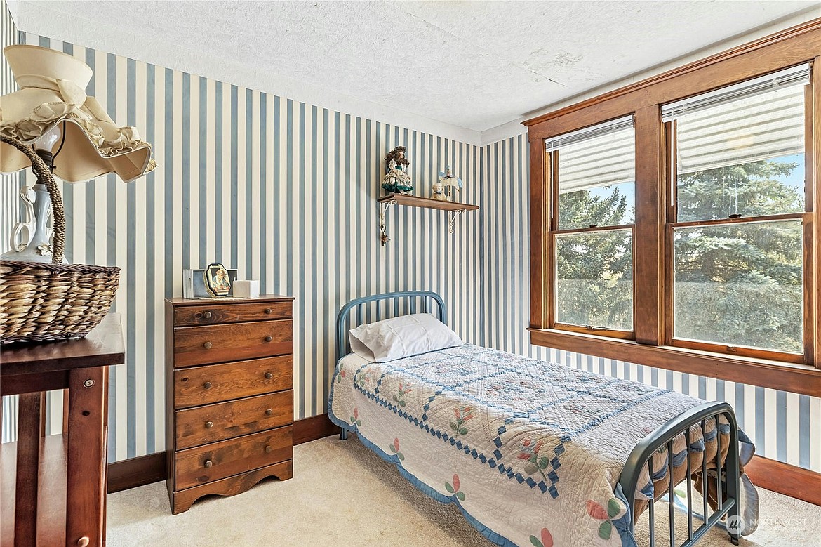 A bedroom in the former mayor of Hatton’s house, also showcasing original wood furnishings. According to the listing the house is about 2,941 square feet.