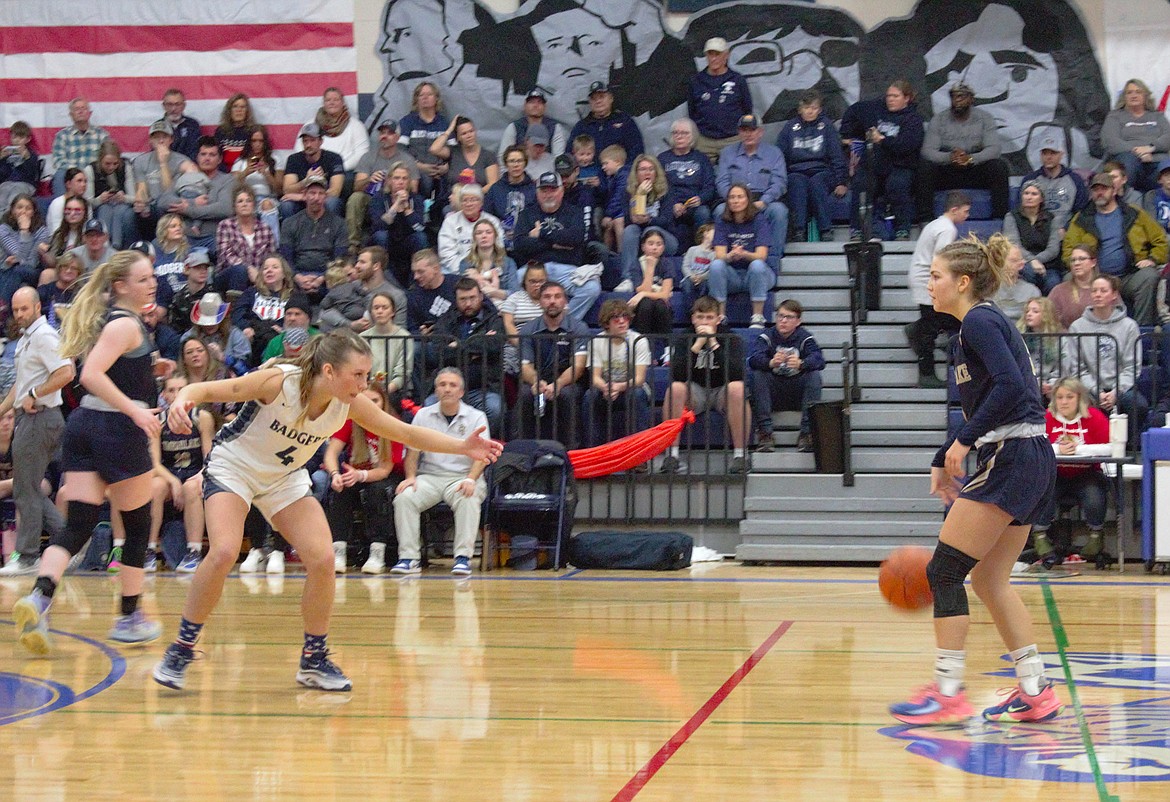 (left) Rylie Kimball plays defense at half court during the varsity girls basketball game as part of the Backwoods Brawl.