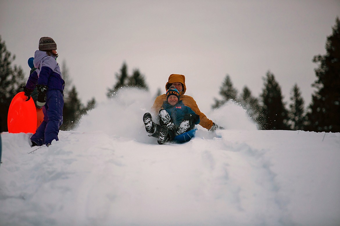 A local youth closes his eyes as his sled gets ready to had down the Pine Street Sled Hill on Tuesday, Jan. 16. The sled hill reopened Sunday after the Kaniksu Land Trust purchased the 48-acre site last year after a successful community fundraising campaign.