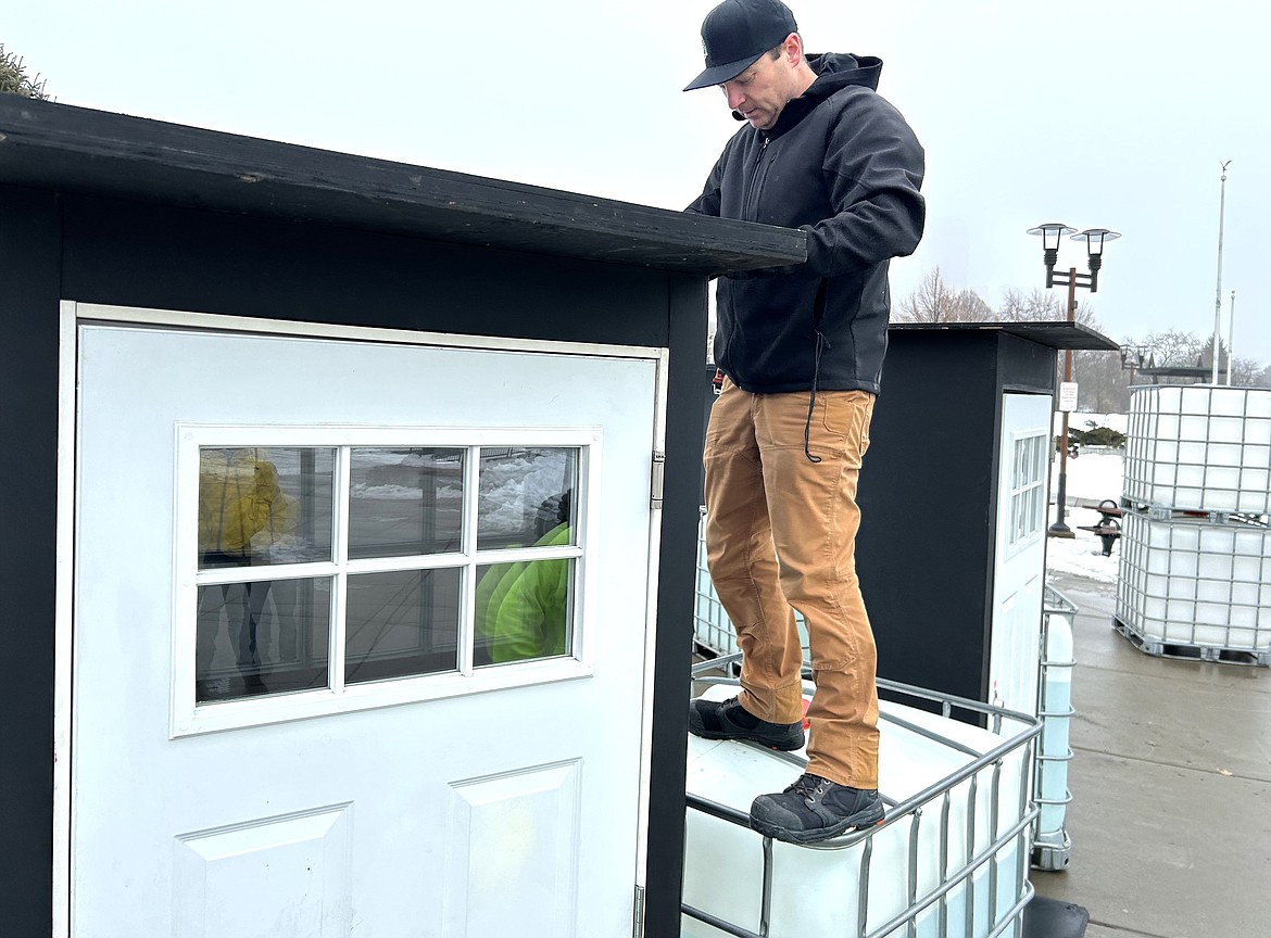 Paul Magnuson with BigArt sets up a door at McEuen Park that will be part of the Winter Lights display that begins Friday.