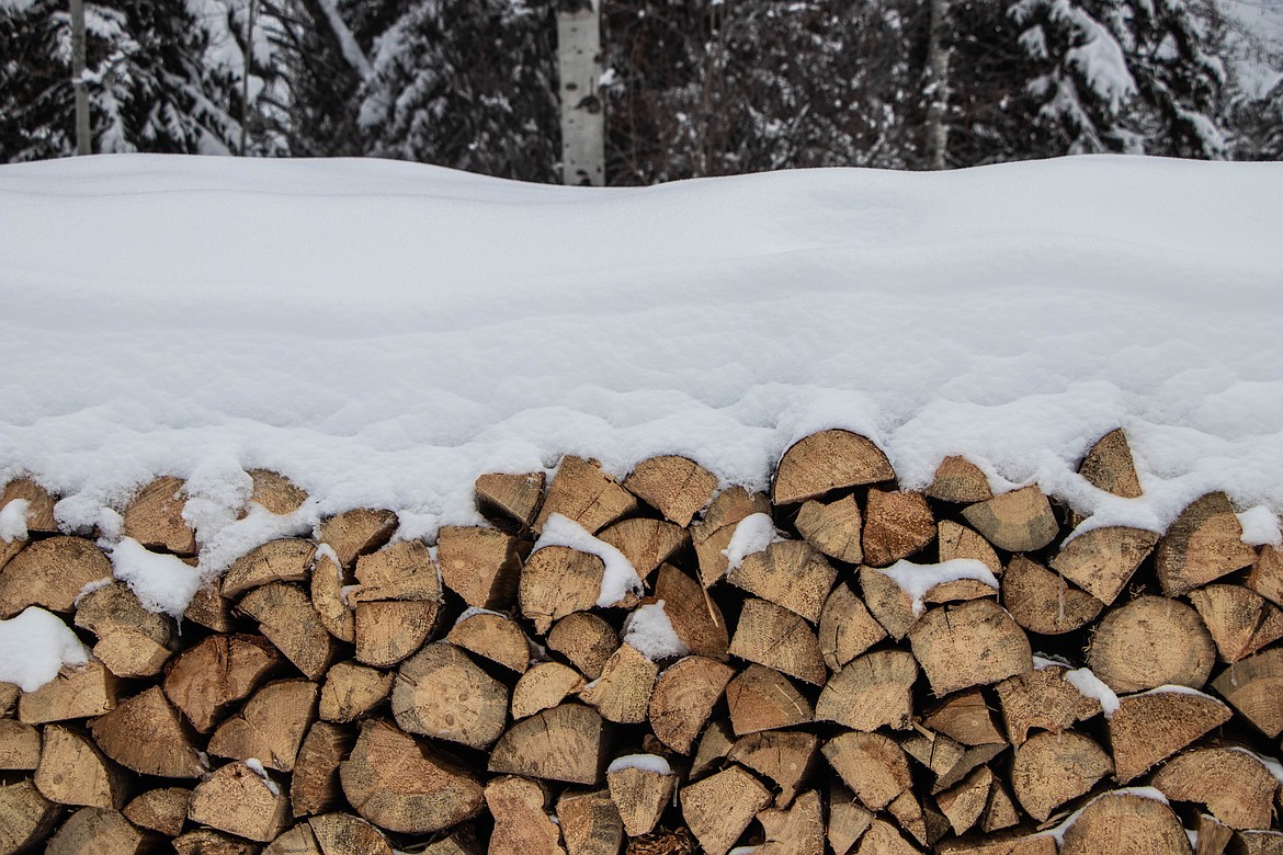 Wood piles, which director Pattiann Bennett, of the St Michael & All Angels Wood Ministry in Fortine, hopes will act as reserves for next year's season. (Kate Heston/Daily Inter Lake)