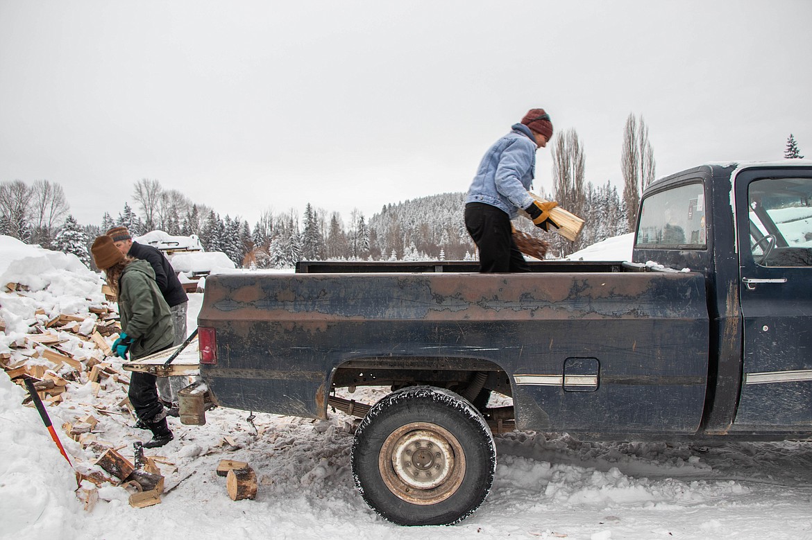 Volunteers load wood into a truck on Jan. 20, 2024 at St Michael & All Angels Wood Ministry in Fortine. (Kate Heston/Daily Inter Lake)