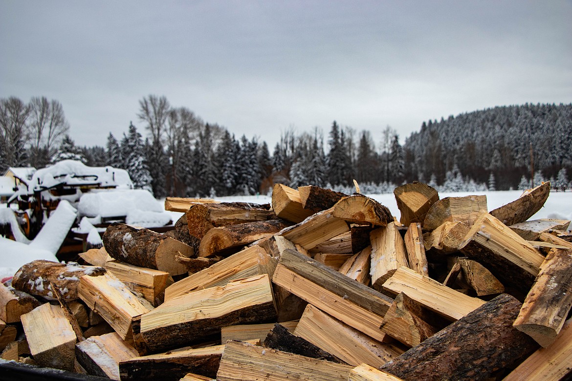 A pile of wood, covered in snow, at the St Michael & All Angels Wood Ministry in Fortine. (Kate Heston/Daily Inter Lake)