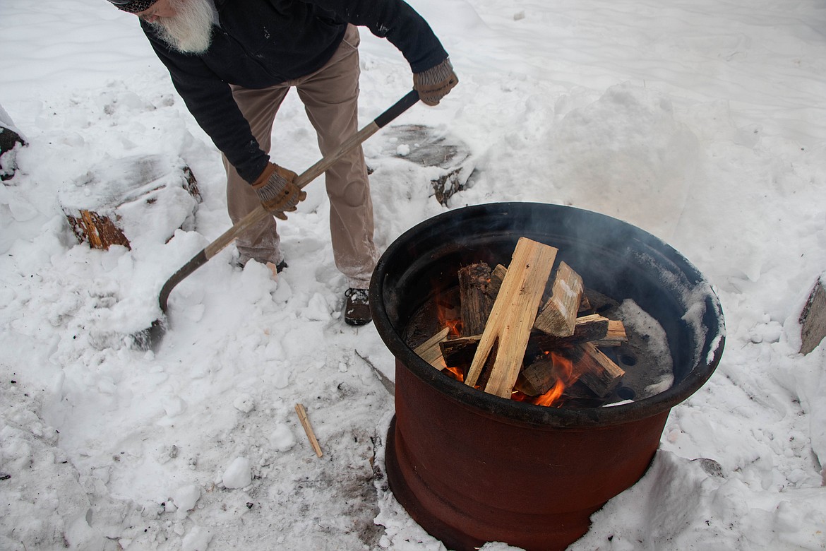 Volunteers maintain a fire on site at the St Michael & All Angels Wood Ministry in Fortine for warmth in the Winter. (Kate Heston/Daily Inter Lake)