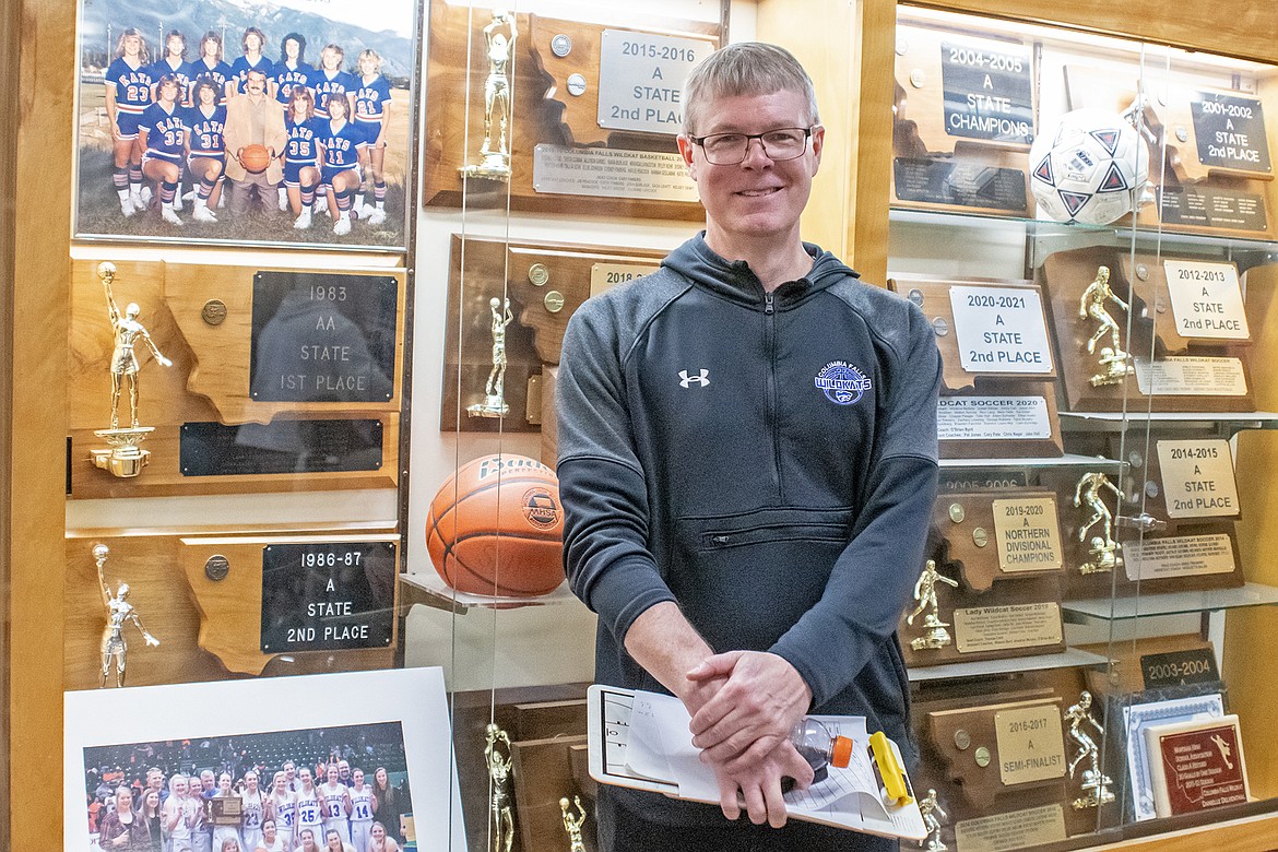 CARY FINBERG poses in front of a trophy case at Columbia Falls High School before his Wildkats faced Ronan on Thursday. (Avery Howe/Hungry Horse News)