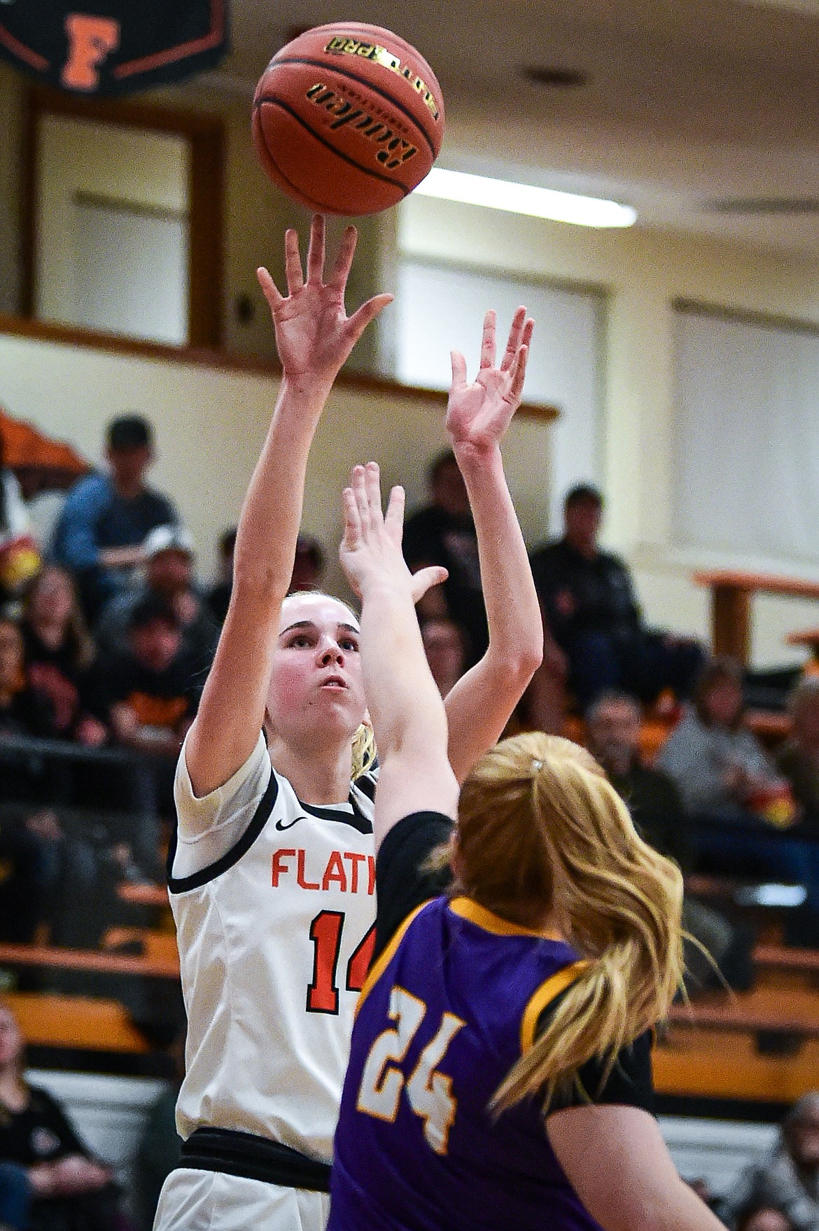 Flathead's Kennedy Moore (14) knocks down a jumper guarded by Missoula Sentinel's Shay Casagrande (24) in the first half at Flathead High School on Thursday, Jan. 25. (Casey Kreider/Daily Inter Lake)