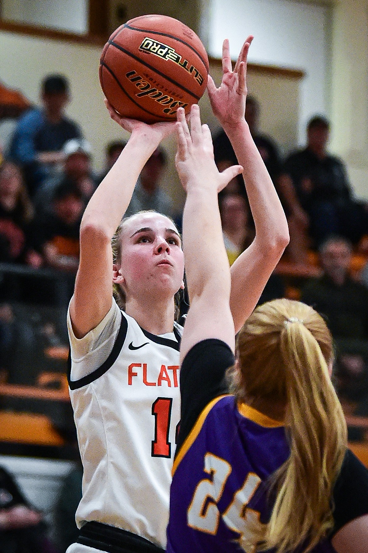 Flathead's Kennedy Moore (14) knocks down a jumper guarded by Missoula Sentinel's Shay Casagrande (24) in the first half at Flathead High School on Thursday, Jan. 25. (Casey Kreider/Daily Inter Lake)